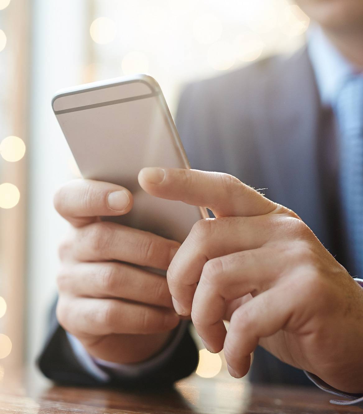 Smartphone in hands of businessman